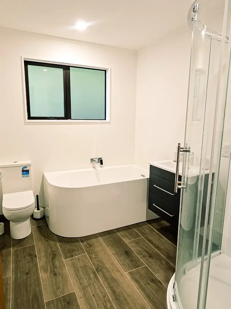 Completed bathroom with tiled shower and fitted vanity