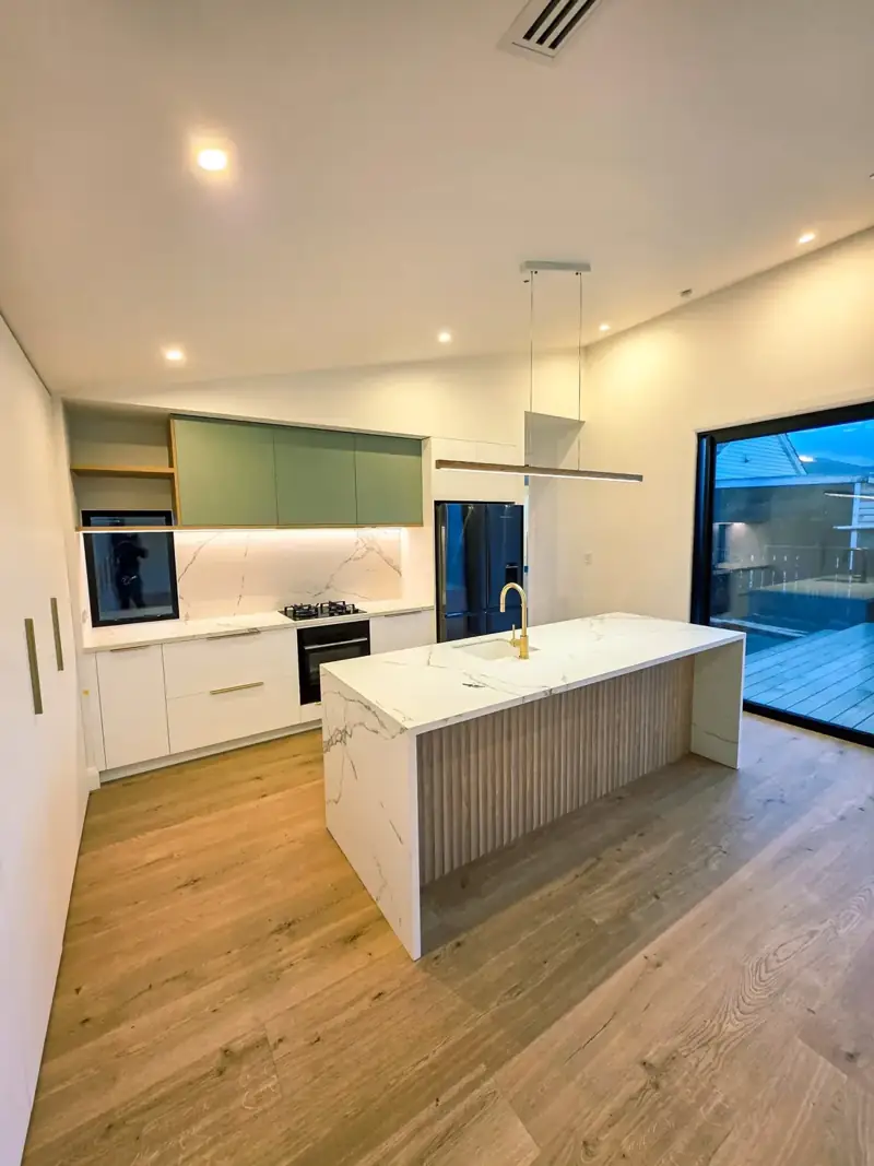 Finished kitchen with cabinetry, island and timber flooring