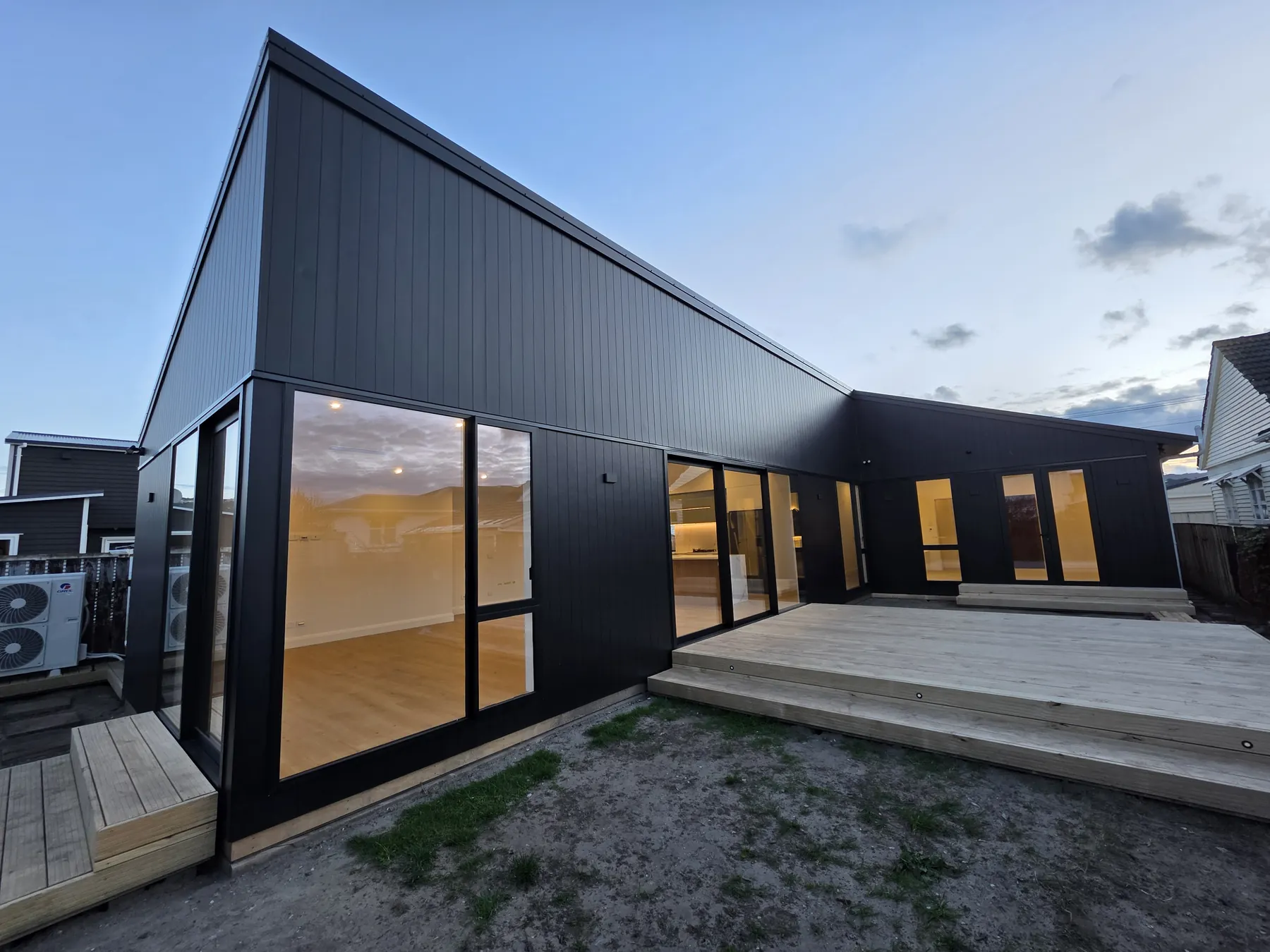 Completed angular extension with dark cladding and expansive glazing