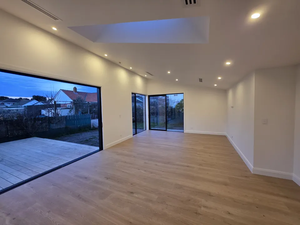 Open living space with skylights and sliding doors