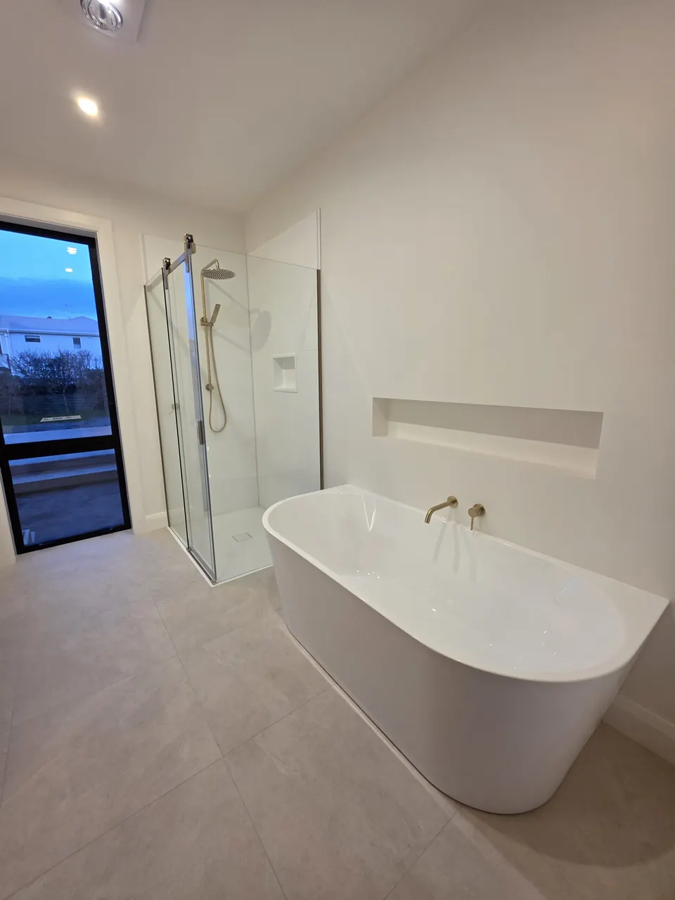 Tiled bathroom with freestanding bath